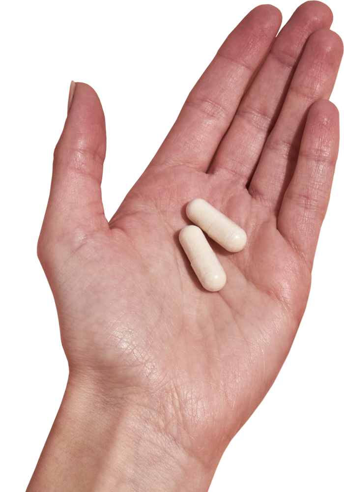 image of hand holding 2 Performance Lab® UK Magnesium capsules