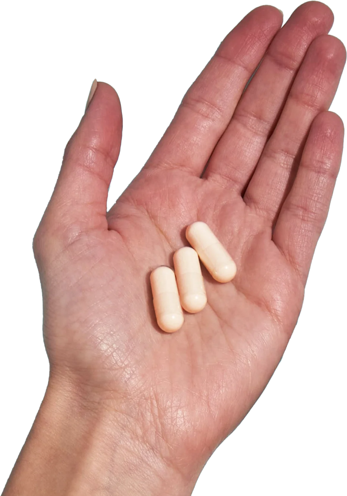 image of hand holding 3 Performance Lab® UK Magnesium capsules