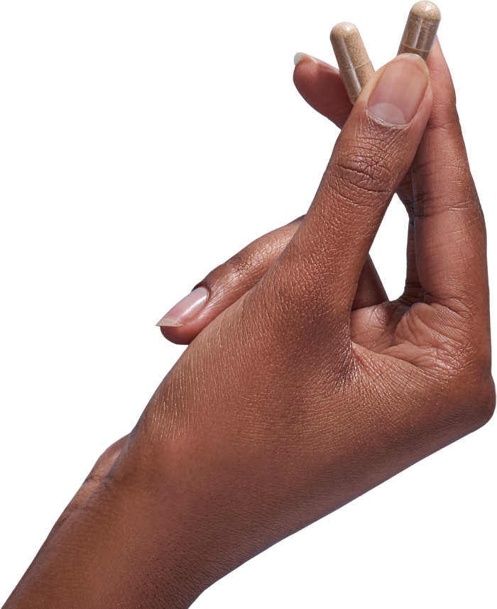 image of hand holding 2 Performance Lab® UK Vitamin C capsules